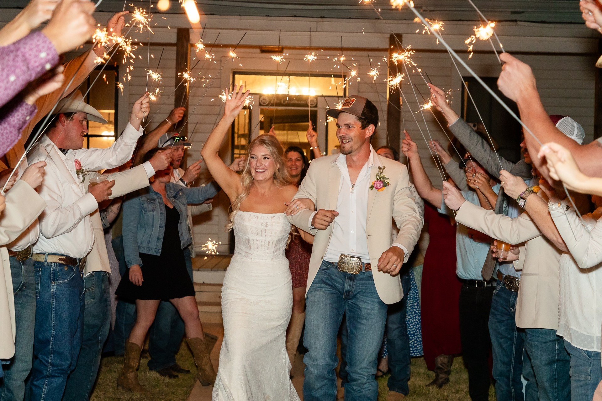 Sparkler exit at Willow Sky Ranch Hill Country wedding — guests line up under the stars